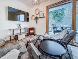 a living room with a couch and a fire place at Apartment Lotus in Ovronnaz