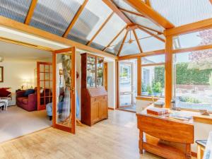 a living room with a table and some windows at 3 Bed in Crieff oc-88631 in Comrie