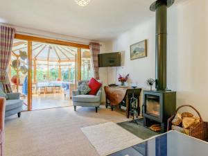 a living room with a fireplace and a living room with at 3 Bed in Crieff oc-88631 in Comrie