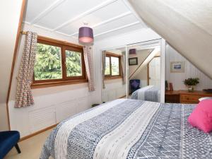 a bedroom with a bed and a window at 3 Bed in Crieff oc-88631 in Comrie