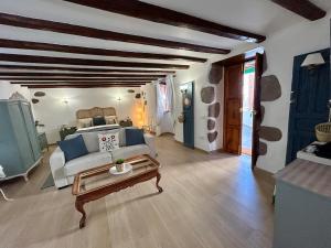 a living room with a white couch and a table at Balcón Néstor Álamo I in Tejeda