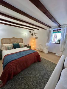 a bedroom with a large bed and a couch at Balcón Néstor Álamo I in Tejeda