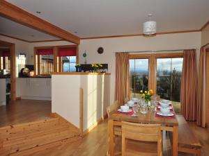 a kitchen and dining room with a table and chairs at 4 Bed in Gairloch oc-29010 in Gairloch