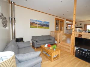 a living room with two couches and a television at 4 Bed in Gairloch oc-29010 in Gairloch +10 photos