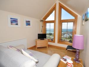 a living room with a couch and a window at 4 Bed in Gairloch oc-29010 in Gairloch