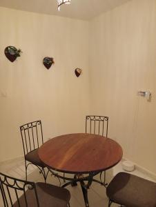 a dining room with a wooden table and chairs at Chez Mounas in Saint-Louis