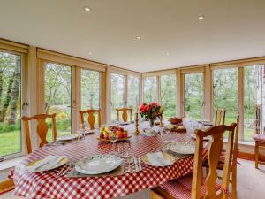 a dining room with a table with a red and white table cloth at 5 Bed in Aberlour oc-ca280 in Carron