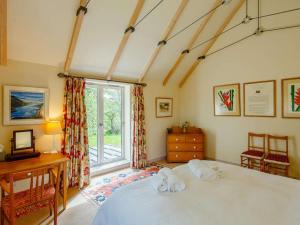 a bedroom with a bed and a desk and a window at 5 Bed in Aberlour oc-ca280 in Carron