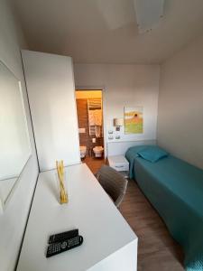 a bedroom with a bed and a table with a remote control at Casa Makeda in Rosate