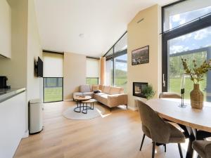 a living room with a table and chairs and a couch at Amsterdam in Oud-Ade