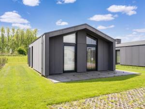 a black and white house on a grass field at Amsterdam in Oud-Ade
