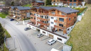 an overhead view of a large apartment building with cars parked outside at Apartment Lotus in Ovronnaz