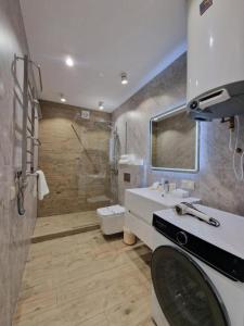a bathroom with a shower and a toilet and a sink at Apartament on StyleUp StayRent Lutsk in Lutsk +16 photos