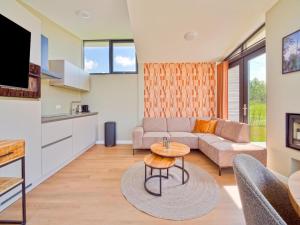 a living room with a couch and a table at Leiden in Oud-Ade
