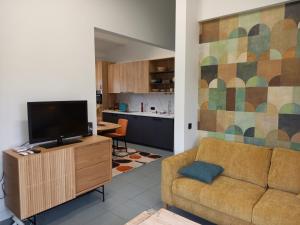a living room with a couch and a kitchen at Casa René in Aalter