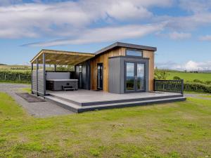 a small house with a deck in a field at 1 Bed in Girvan oc-78072 in Girvan +9 photos