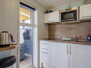 a kitchen with a sink and a microwave at 1 Bed in Girvan oc-78072 in Girvan