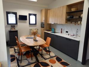 a kitchen with a wooden table and chairs at Casa René in Aalter +10 photos