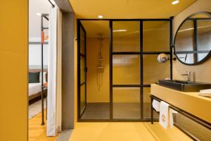 a bathroom with a shower with a sink and a mirror at Inspira Santos Boutique Hotel in Lisbon +122 photos
