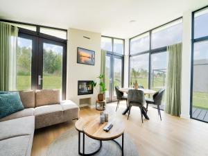 a living room with a couch and a table at Polder in Oud-Ade