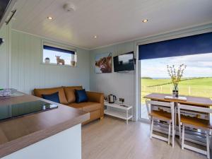 a kitchen and living room with a couch and a table at 1 Bed in Girvan oc-78073 in Girvan