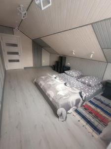 a bedroom with a large bed in a attic at Міні садиба in Lazeshchyna