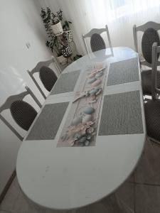 a white table with chairs around it at Міні садиба in Lazeshchyna