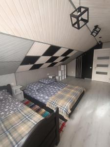 a room with two beds in a attic at Міні садиба in Lazeshchyna