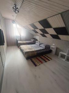a large bedroom with two beds in a attic at Міні садиба in Lazeshchyna