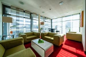 a large living room with couches and a table at Qualitel Wilnsdorf in Wilnsdorf