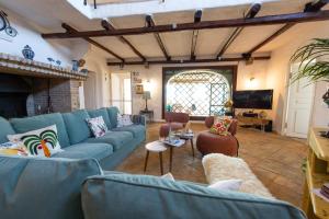 a living room with a blue couch and chairs at Kite Hostel Stagnone in Marsala