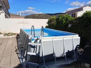 a swimming pool with a ladder next to a boat at La murallita de Aroa in Cañete