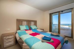 a bedroom with a large bed with a view of the ocean at Casa Paulo - Aguilón Golf in San Juan de los Terreros