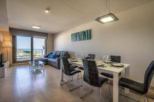a living room with a table and chairs and a couch at Casa Paulo - Aguilón Golf in San Juan de los Terreros
