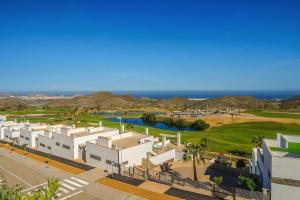 a view of a resort with the ocean in the background at Casa Paulo - Aguilón Golf in San Juan de los Terreros