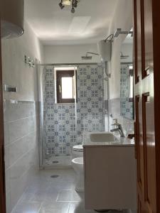 a bathroom with a toilet and a sink at La Scaletta - Charming Historic Center Home - Mountain View in San Nicola Arcella
