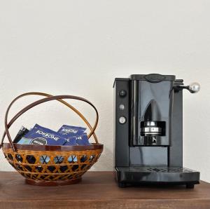 a coffee machine and a basket on a table at La Scaletta - Charming Historic Center Home - Mountain View in San Nicola Arcella