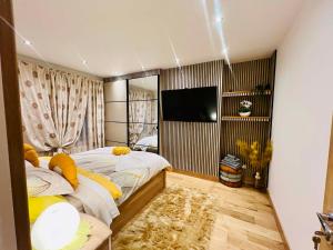 a bedroom with two beds and a flat screen tv at Arnie in Longley