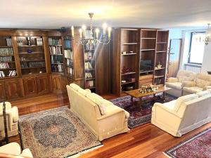a living room with two chairs and a chandelier at Residenza Arilica - Silkeys in Peschiera del Garda