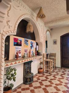 a living room with a fireplace and a checkerboard floor at Haven Hills Chaouen in Chefchaouen