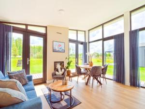 a living room with a blue couch and a table at Kaag in Oud-Ade