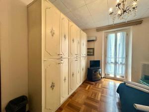 a room with white cabinets and a chandelier at Suite in Private Villa in Milan +51 photos