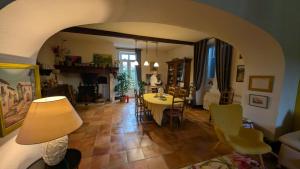 a living room with a table and a dining room at B&B chez Nicole in Montaut