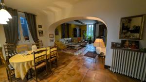 a living room with a table and a dining room at B&B chez Nicole in Montaut