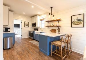 a kitchen with a blue island in the middle at Kildahl House - Boutique Farmhouse Suite #3 in West Dundee