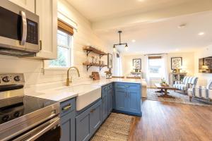 a kitchen with blue cabinets and a sink at Kildahl House - Boutique Farmhouse Suite #3 in West Dundee