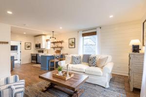 a living room with a white couch and a table at Kildahl House - Boutique Farmhouse Suite #3 in West Dundee