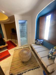 a living room with a couch and a large window at Hôtel Djerba Authentique - Au centre de Midoun in Midoun