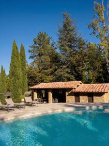 a swimming pool in a yard with a pavilion at Residenza Castelnovo in Gubbio