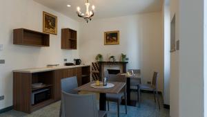 a kitchen and dining room with a table and chairs at BORGO MARE 86 rooms in Porto SantʼElpidio